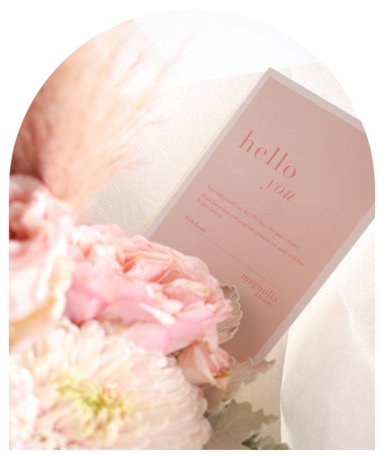 A Magnolia Blooms hello you card tucked among blush blooms